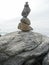 Stack of rocks balancing on sky background