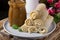 Stack of rolled crepes on the ceramic plate, a glass jar of salted caramel