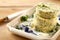 Stack of round herb butter pats on a tray