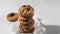 Stack of round oat biscuit cookies with raisins on white background, selective focus