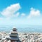 Stack of rounded stones zen-like and blue sky with clouds