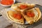 Stack of russian thin pancakes blini with red caviar on an old wooden table. Maslenitsa, traditional Russian blini