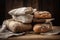 stack of rustic, handcrafted loaves on tablecloth-dressed wooden table