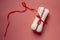 A stack of sanitary pads or Feminine hygiene pads tied with a red ribbon on a pink background. Critical days, Intimate, Period