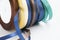 Stack of satin ribbon coils. Blue, green, brown and yellow ribbon for handmade. Needlework items.