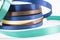 Stack of satin ribbon coils. Blue, green, brown and yellow ribbon for handmade. Needlework items.