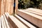 Stack of sawed wooden planks or timber at a construction site