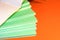 A stack of school green notebooks on a bright background