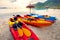 Stack of sea kayak on beautiful sand beach against morning usn rising