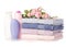 A stack set towels plastic bottle with cosmetic cream lotion gel for body flower