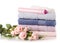 A stack set towels plastic bottle with cosmetic cream lotion gel for body flowers