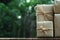 Stack of simple eco friendly gift box package wrap with brown paper in old wooden table background, green present concept