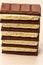 Stack of six black and five white porous chocolate closeup on table