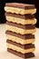 Stack of six dark and five white porous chocolate closeup on table