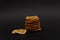 Stack of sliced dried dehydrated oranges and two sliced of dried oranges nearby