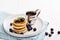 Stack of small pancakes with berries