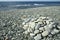 stack of small smooth stones on shore