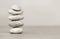 A stack of smooth gray pebbles. shallow depth of field.