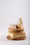 Stack of soft French cow`s milk cheese on a cutting board on white. Camembert, Livarote, Pont-L`eveque cheese from Normandy. Cop