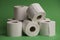 Of a stack of soft toilet paper rolls on a green background