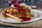 Stack of spelt pancakes with russian jam and cottage cheese