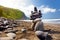 Stack of stones balanced on rocky beach of Pololu Valley, Big Island, Hawaii