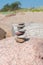 Stack of stones on sand beach near sea. Zen garden. Pebble tower