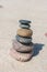 Stack of stones on sand beach near sea. Zen garden. Pebble tower