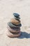 Stack of stones on sand beach near sea. Zen garden. Pebble tower