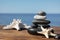 Stack of stones and starfishes on wooden pier near sea, Zen concept