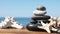 Stack of stones and starfishes on wooden pier near sea. Zen concept