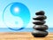 Stack of stones on wooden table outdoors and Ying Yang symbol. Feng Shui philosophy