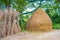 Stack of straw after harvest on the side of a country road. Dry haystack for cattle feed. Harvesting forage for the