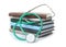 Stack of student textbooks and stethoscope on white background.
