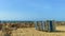 Stack of sun loungers on the sandy beach on the background of a not very stormy sea and the waves of which break on the breakwater