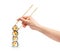 Stack of sushi rolls with wooden chopsticks in female hand