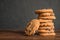 Stack of tasty chocolate chip cookies on wooden table.