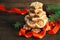 Stack of tasty gingerbread cookies, ribbon and Christmas tree branch on wooden background, close up