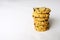 Stack of tasty homemade oats and cranberry cookies on white background. Copy space
