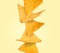 Stack of tasty tortilla chips on beige background