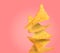 Stack of tasty tortilla chips on salmon color background, space for text
