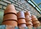 Stack of terracotta planters on the shelf of backyard