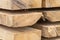 Stack of thick boards new part of warehouse building material background texture