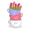 Stack of three colorful teacups with heart symbols and flowers. I love you message with floral decoration. Romantic gift