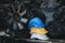 Stack of three colorful worker helmets at workplace manufacturing plant factory construction site building with many engine parts