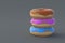 Stack of three donuts on gray background. Homemade bakery