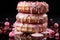 a stack of three donuts with pink frosting and sprinkles