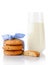 Stack of three homemade oatmeal cookies tied with blue ribbon in small white polka dots, half of cookie and glass of milk