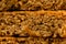Stack of three pieces of golden syrup flapjack as background, healthy sweet snack