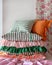 A stack of three striped pillows with curled edges, displayed on a shelf